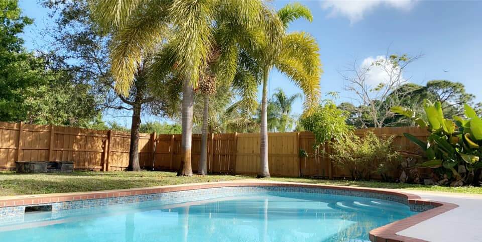 The in ground pool at Cayuga Sober Living in Port St Lucie, Florida